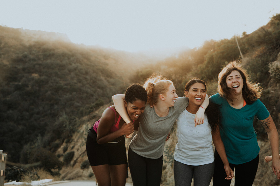 Group of Women outside with a sunset far behind them